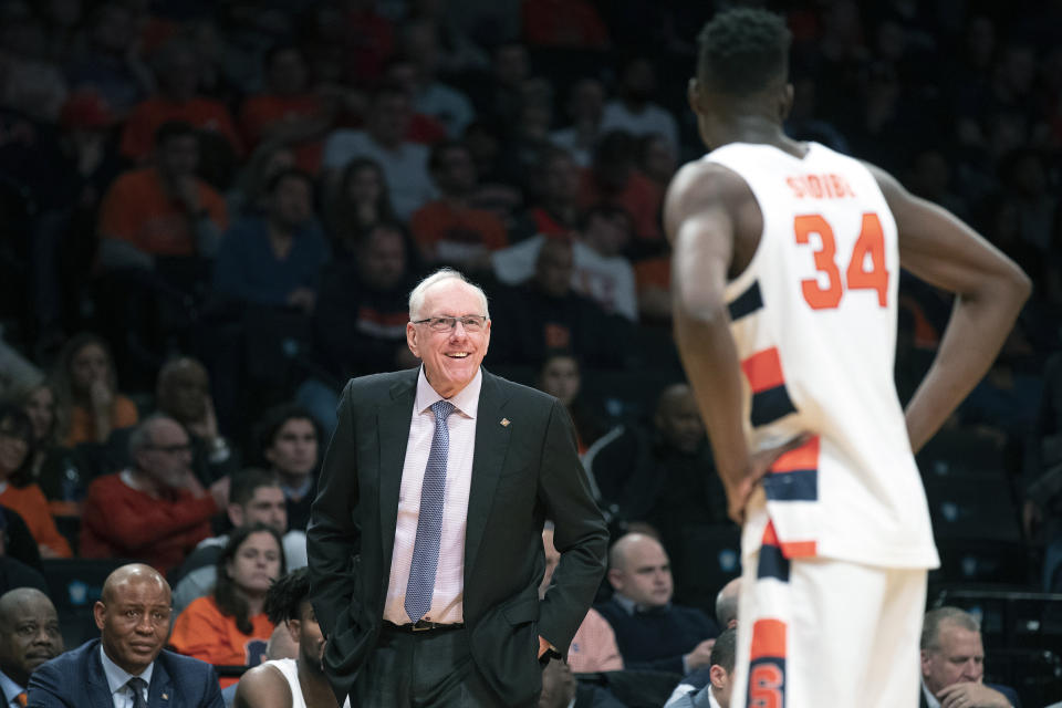 Syracuse head coach Jim Boeheim talks to forward Bourama Sidibe (34) during the second half of an NCAA college semi final basketball game against the Oklahoma State in the NIT Season Tip-Off tournament, Wednesday, Nov. 27, 2019, in New York. Oklahoma State won 86-72. (AP Photo/Mary Altaffer)