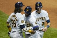 Milwaukee Brewers' Ryan Braun celebrates his three-run home run with Jacob Nottingham (26) and Christian Yelich during the eighth inning of a baseball game against the Kansas City Royals Saturday, Sept. 19, 2020, in Milwaukee. (AP Photo/Morry Gash)