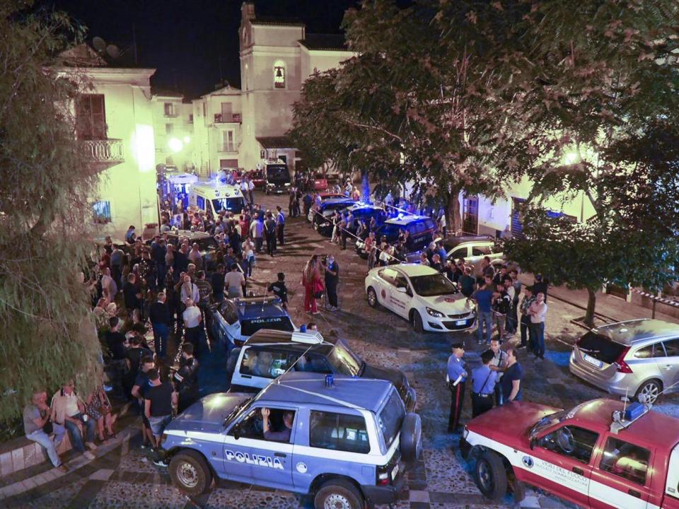 Rescuers and citizens wait in the central square of Civita as rescue squads worked through the night with spotlights (KONTROLAB/AFP/Getty Images)