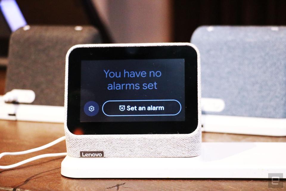 <p>A gray Lenovo Smart Clock 2 on a wireless charging dock with its screen facing the camera. The display shows the Alarm page, with the words "You have no alarms set" and a button saying "Set an alarm."</p>
