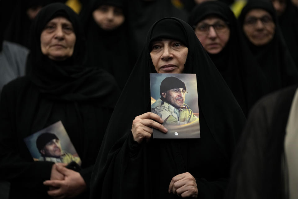 Hezbollah supporters hold portraits of Hezbollah slain top commander Mustafa Badreddine, who was killed in Syria, as they listen to Hezbollah leader Sayyed Hassan Nasrallah during a ceremony to mark the seven anniversary of his death, in the southern suburbs of Beirut, Lebanon, Friday, May 12, 2023. Nasrallah denied reports that linked one of Syria's most well-known drug dealers who was killed earlier this week in an airstrike near the Jordanian border to the Iran-backed group calling such accusations "baseless lies." (AP Photo/Hussein Malla)
