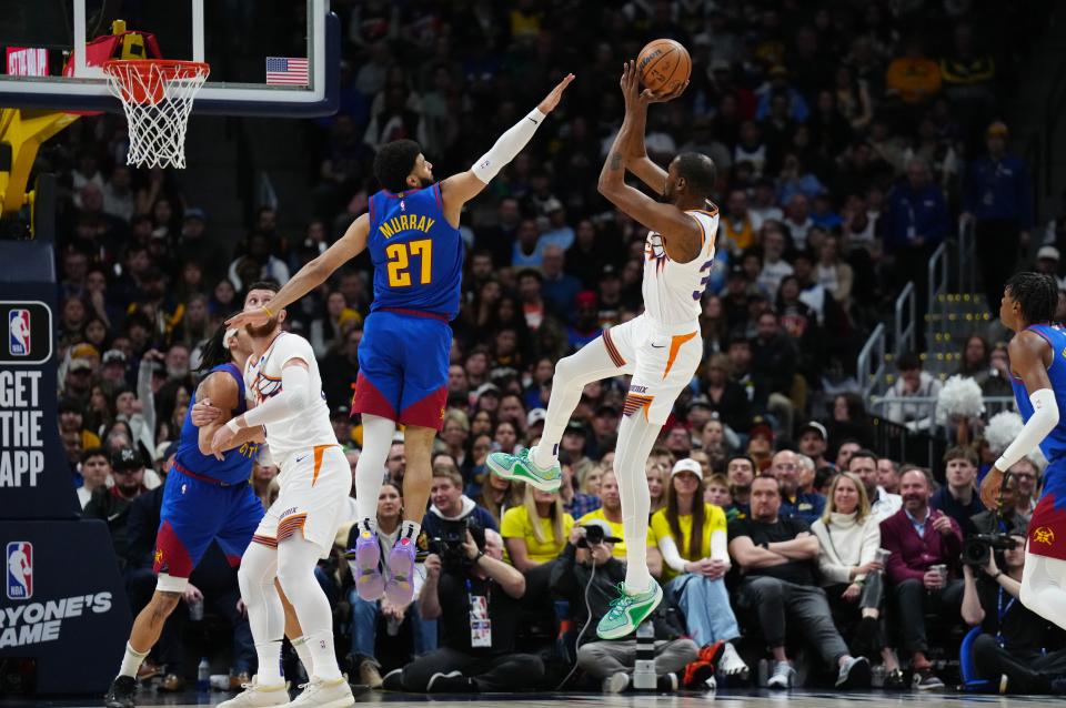 Phoenix Suns forward Kevin Durant (35) shoots the ball over Denver Nuggets guard Jamal Murray (27) in the first half at Ball Arena in Denver, Colorado on March 5, 2024.