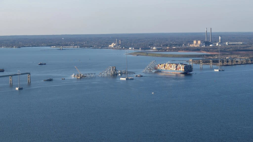 In this photo provided by the U.S. Coast Guard, the M/V Dali is shown with the collapsed Francis Scott Key Bridge, Saturday, March 30, 2024, in Baltimore. (Petty Officer 3rd Class Kimberly Reaves/U.S. Coast Guard via AP)