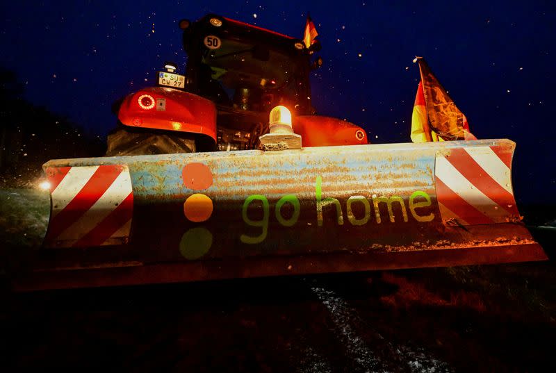 German farmers take part in a protest against the cut of vehicle tax subsidies