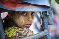 An ethnic Rohingya travels near a confinement camp set up outside the city of Sittwe in Myanmar's Rakhine state, on May 22, 2015