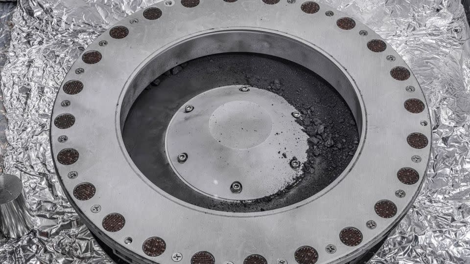 Rocks and dust can be seen outside of the OSIRIS-REx sample collector, but the bulk of the sample is located inside. - Erika Blumenfeld & Joseph Aebersold/NASA
