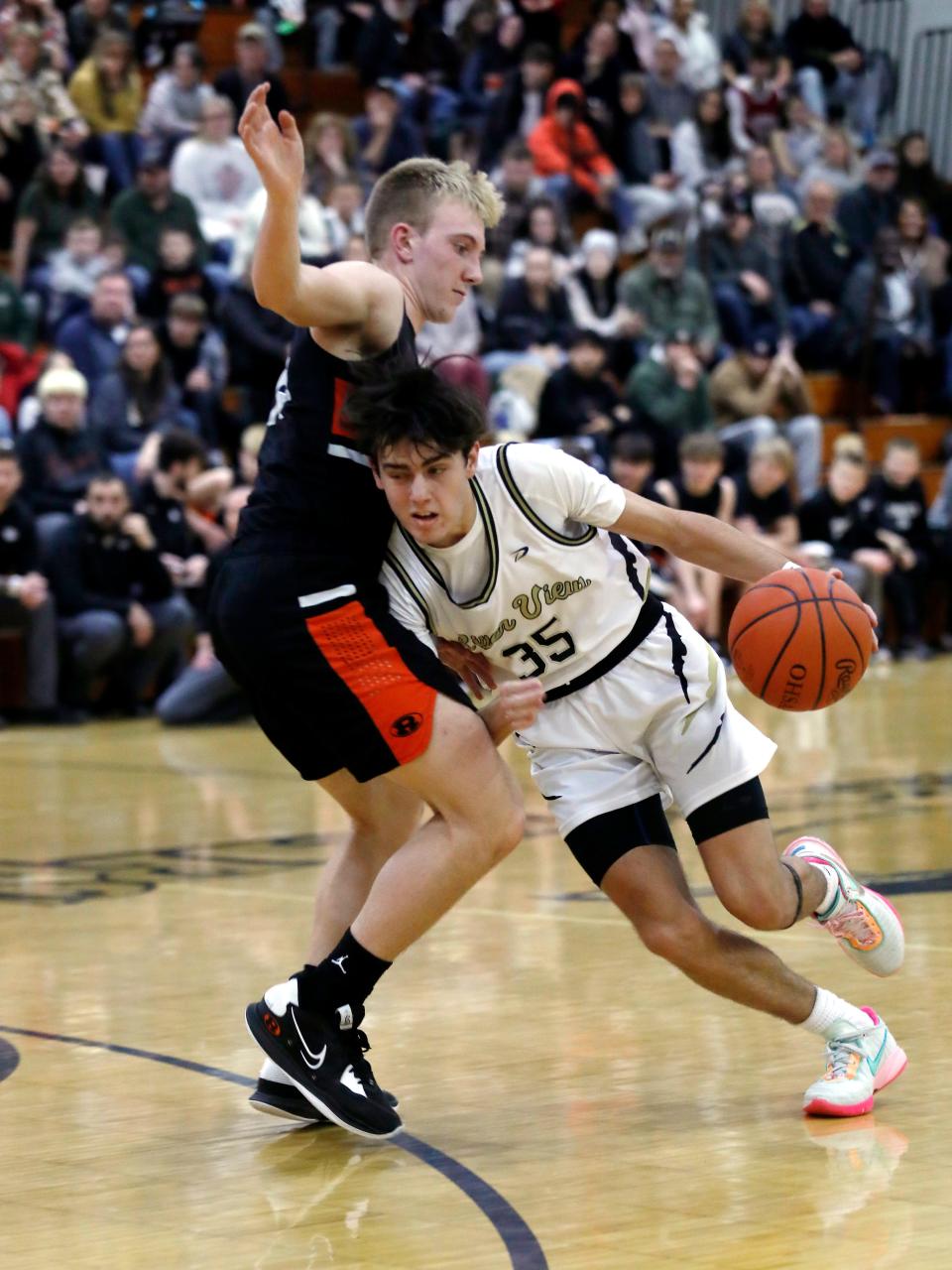 River View's Owen Emig drives on Ridgewood's Grant Lahmers on Tuesday night during the Coshocton County Classic at Luther Stover Gymnasium in Warsaw.