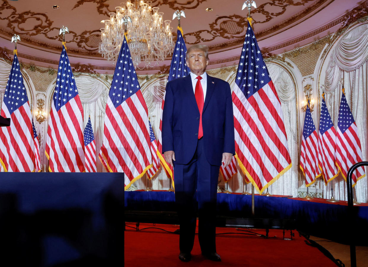 Former U.S. President Donald Trump stands onstage listening to applause as he arrives to announce that he will once again run for U.S. president in the 2024 U.S. presidential election during an event at his Mar-a-Lago estate in Palm Beach, Florida, on Nov. 15, 2022.