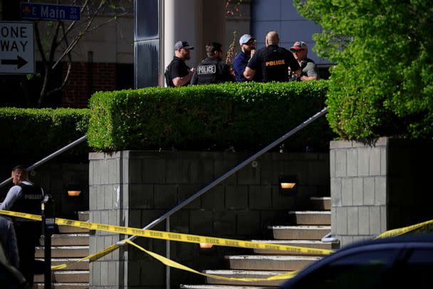 PHOTO: Law enforcement officers gather outside the front entrance of the Old National Bank building after a gunman opened fire on April 10, 2023 in Louisville, Ky. (Luke Sharrett/Getty Images)