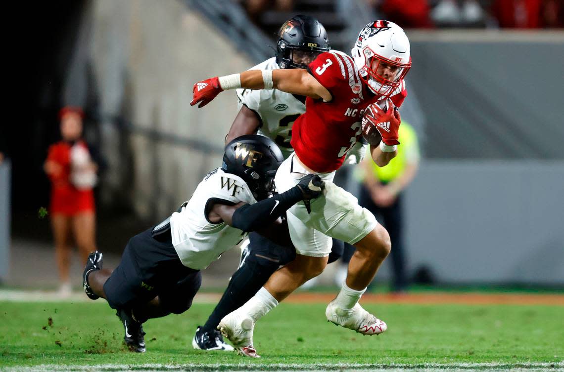 N.C. State running back Jordan Houston (3) tries to break from Wake Forest defensive back Malik Mustapha (3) during the second half of N.C. State’s 30-21 victory over Wake Forest at Carter-Finley Stadium in Raleigh, N.C., Saturday, Nov. 5, 2022.