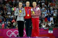 <p>Silver medallist McKayla Maroney Maroney (L) of the United States, gold medallist Sandra Raluca Izbasa (C) of Romania and bronze medallist Maria Paseka of Russia pose with their medals during the medal ceremony following the Artistic Gymnastics Women’s Vault final on Day 9 of the London 2012 Olympic Games at North Greenwich Arena on August 5, 2012 in London, England. (Photo by Ronald Martinez/Getty Images) </p>