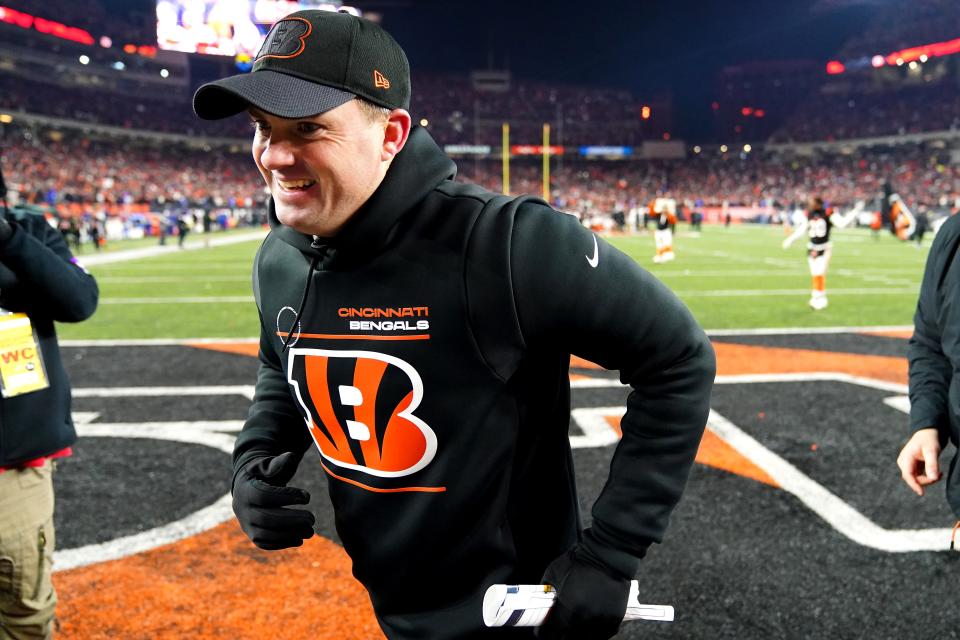 Cincinnati Bengals head coach Zac Taylor gestures toward the fans coming off the field at the conclusion of the fourth quarter during an NFL AFC wild-card playoff game, Saturday, Jan. 15, 2022, at Paul Brown Stadium in Cincinnati.  The Cincinnati Bengals defeated the Las Vegas Raiders, 26-19 to win the franchise's first playoff game in 30 years.