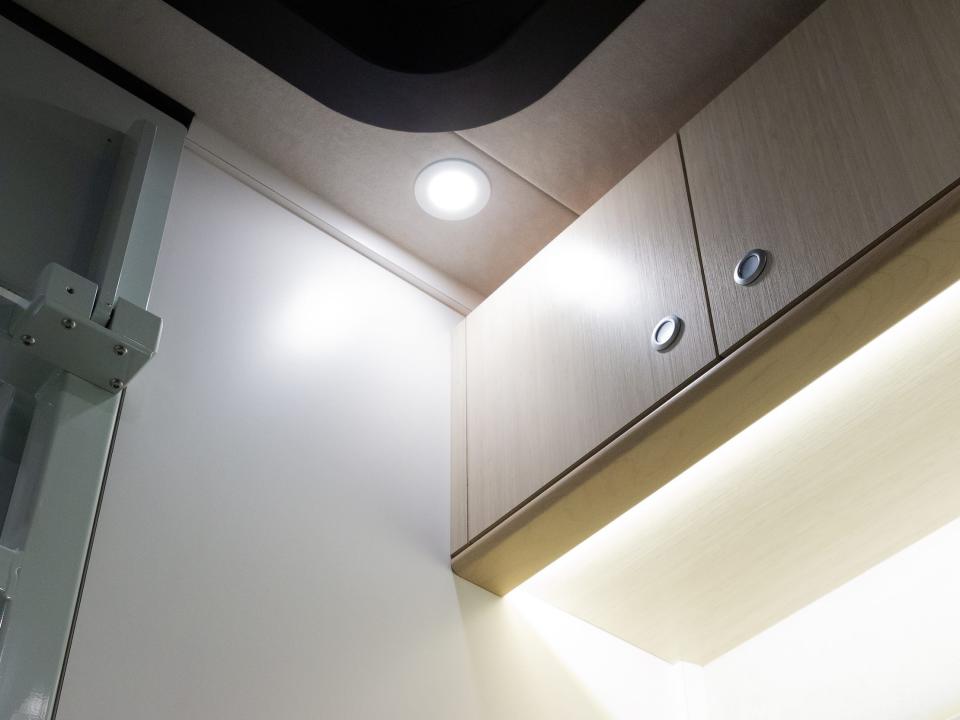 a light shining on cabinets inside the Asteroid of Happiness B Box RV.