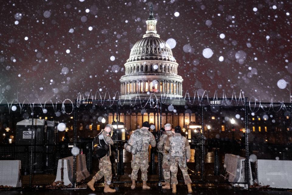 Snow falls over the U.S. Capitol grounds