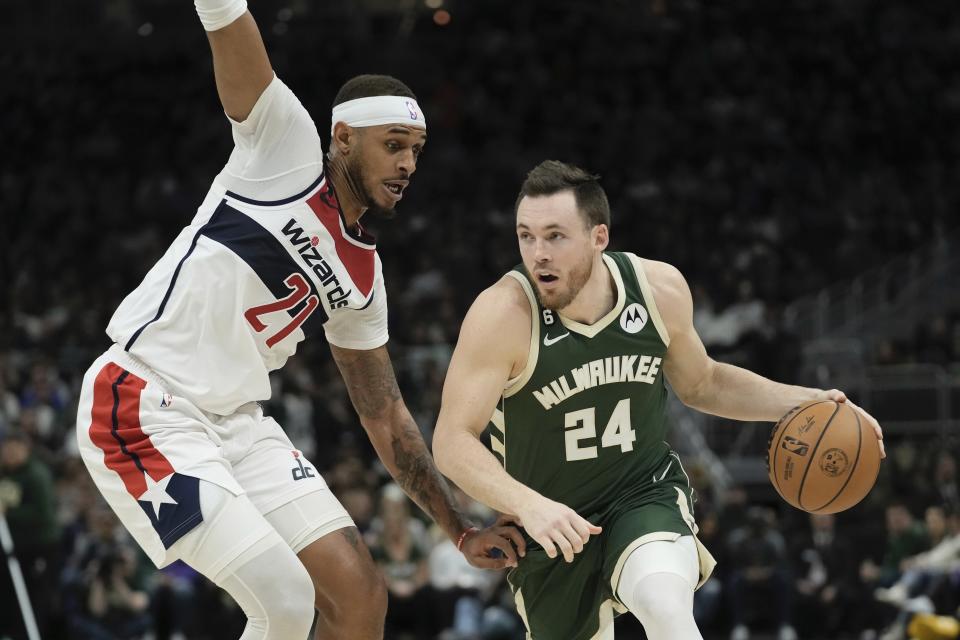 Milwaukee Bucks' Pat Connaughton tries to get past Washington Wizards' Daniel Gafford during the first half of an NBA basketball game Tuesday, Jan. 3, 2023, in Milwaukee. (AP Photo/Morry Gash)