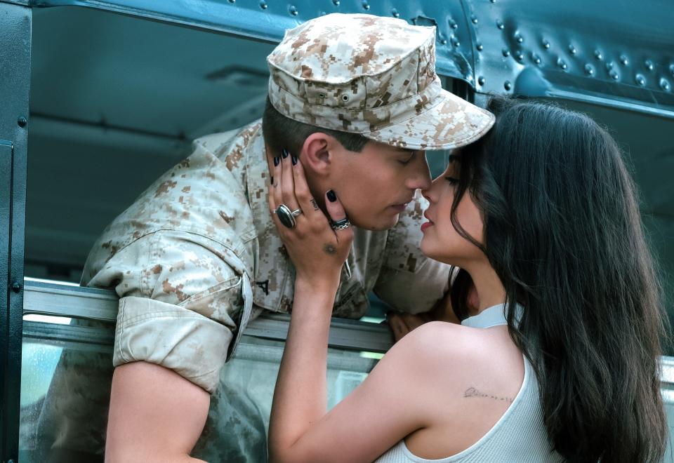 A struggling singer-songwriter (Sofia Carson) and a Marine (Nicholas Galitzine) with a troubled past agree to marry for the military benefits until tragedy complicates their lives in the romantic drama "Purple Hearts."