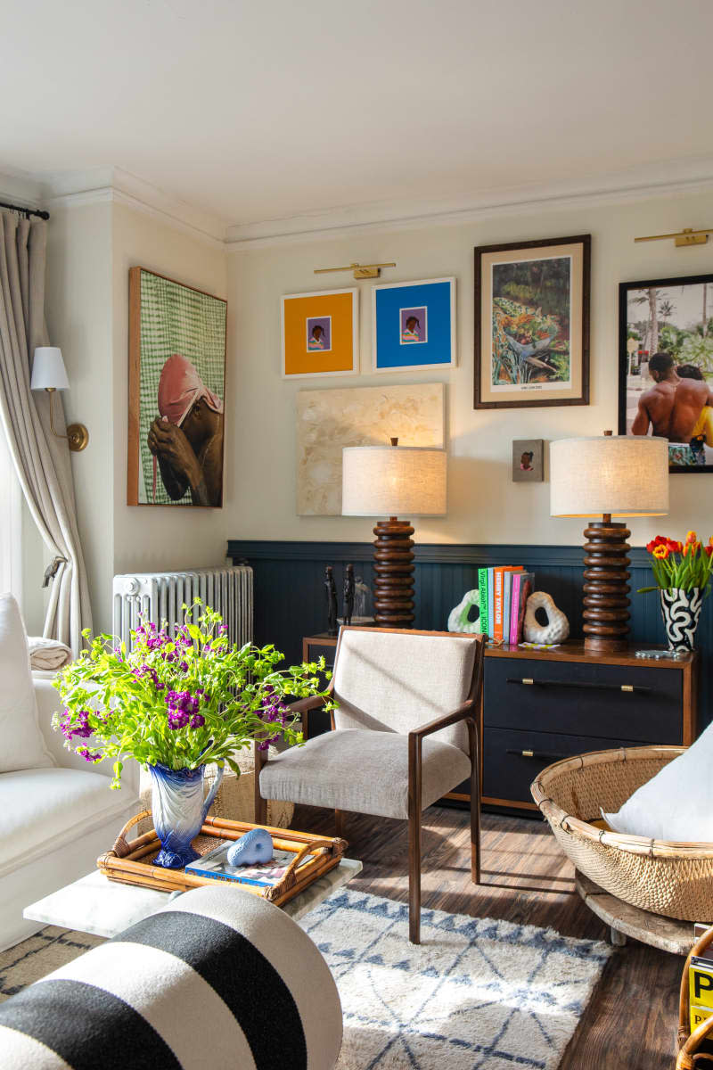 white living room with teal wainscoting and lots of art/gallery wall