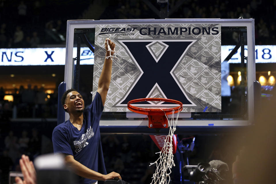 Trevon Bluiett holds up a piece of net after Xavier clinched its first Big East regular-season championship. (AP)