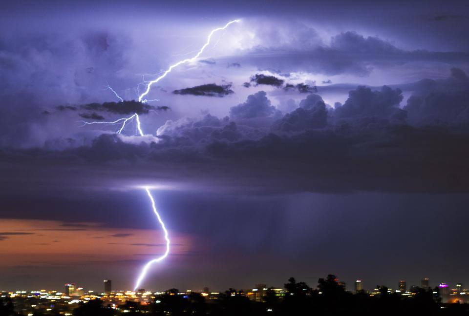 Lightning strikes as rain falls over Phoenix during a monsoon storm on Aug. 7, 2022.