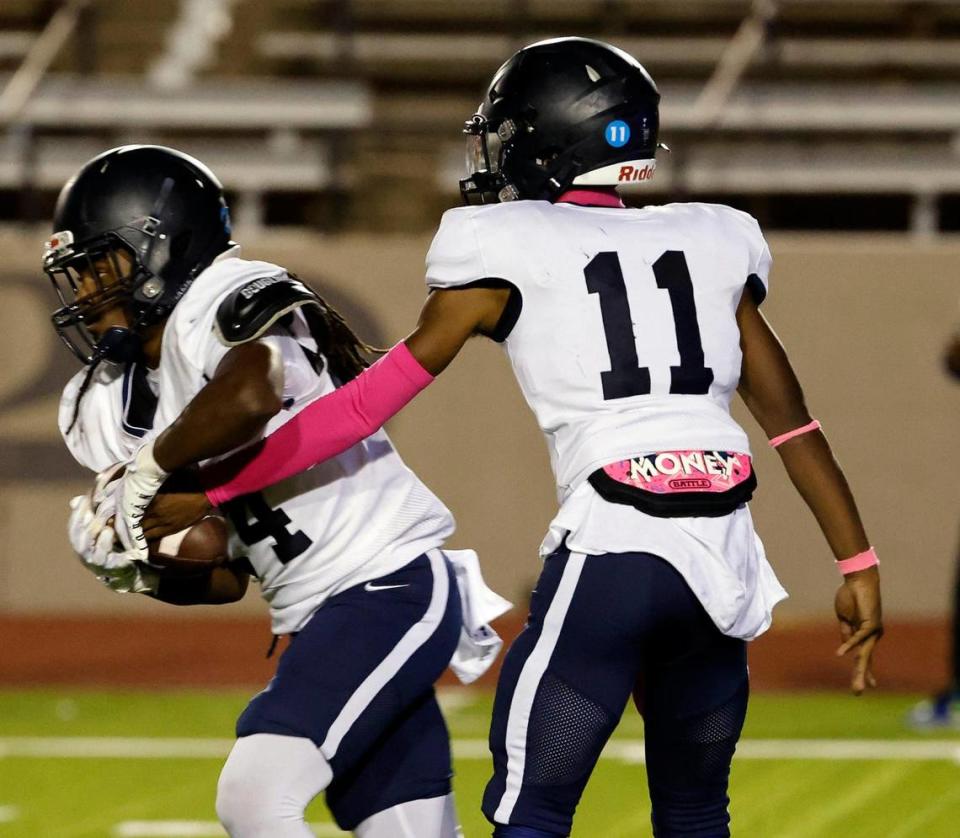 Wyatt running back Jailon Stokes-Magee(24) takes the hand off from Wyatt quarterback Dartagnan Crawford (11) in the first half of a UIL football game at Farrington Field in Fort Worth, Texas, Friday, Oct. 06, 2023.