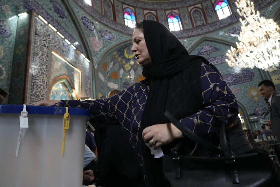 A woman casts her ballot during the Iranian presidential election at a polling station in Tehran, Iran, Friday, June 28, 2024. Iranians were voting Friday in a snap election to replace the late President Ebrahim Raisi, killed in a helicopter crash last month, as public apathy has become pervasive in the Islamic Republic after years of economic woes, mass protests and tensions in the Middle East. (AP Photo/Vahid Salemi)