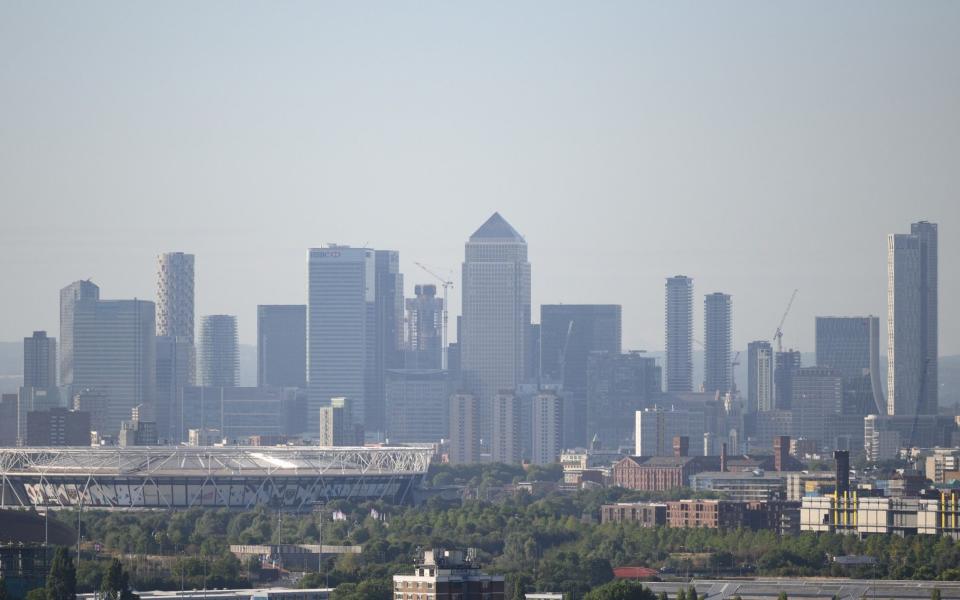 LONDON, ENGLAND - AUGUST 22: The Canary Wharf financial district is seen on the horizon, beyond the residential areas and streets on August 22, 2022 in London, England. The Bank of England has predicted the UK is likely to enter a recession in 2022, with soaring living costs heavily impacting households. (Photo by Leon Neal/Getty Images) - Leon Neal/Getty Images