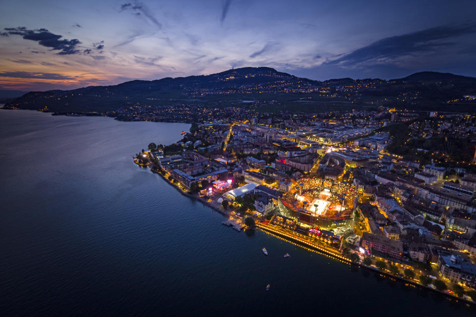 An aerial view shows the full arena of the "Fete des Vignerons" (winegrowers' festival in French), with a capacity of 20,000 spectators and hosting a giant central LED floor of approximately 800 square meters, during the crowning ceremony of the opening night in Vevey, Switzerland Thursday, July 18, 2019. Organized in Vevey by the brotherhood of winegrowers since 1979, the event will celebrate winemaking from July 18 to August 11 this year. (Valentin Flauraud/Keystone via AP)