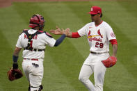 St. Louis Cardinals relief pitcher Alex Reyes (29) and catcher Yadier Molina (4) celebrate after defeating the Milwaukee Brewers in a baseball game Thursday, April 8, 2021, in St. Louis. (AP Photo/Jeff Roberson)
