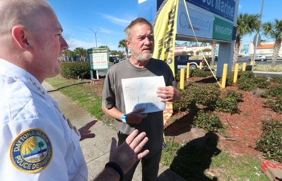 A U.S. District Court judge has issued an order temporarily blocking enforcement of Daytona Beach's panhandling ordinance. Pictured is former Daytona Beach Police Chief Craig Capri giving a warning to a panhandler the day after the city passed an anti-panhandling ordinance in February 2019.