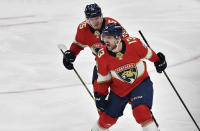 Florida Panthers center Sam Reinhart (13) celebrates scoring the game-winning goal with teammate Anton Lundell during overtime of Game 3 of an NHL hockey Stanley Cup second-round playoff series against the Toronto Maple Leafs, Sunday, May 7, 2023, in Sunrise, Fla. (AP Photo/Michael Laughlin)