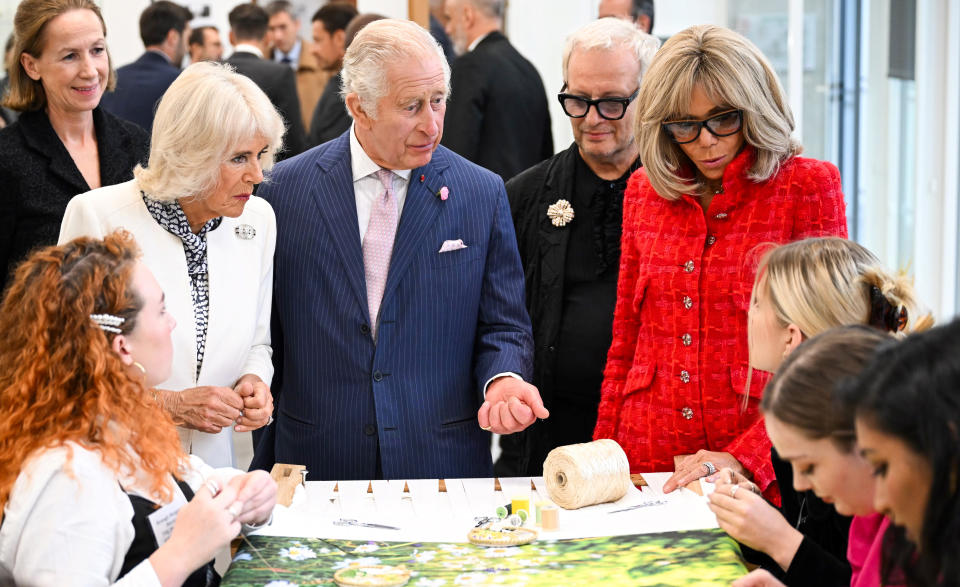 Britain's Queen Camilla, second left, Britain's King Charles III and French President's wife Brigitte Macron visit the 19M Campus, founded by the French luxury fashion house Chanel, Thursday, Sept. 21, 2023 in Paris. The royal couple's trip started Wednesday with a ceremony at Arc de Triomphe in Paris and a state dinner at the Palace of Versailles. King Charles will visit the Paris flower market named after his late mother, Queen Elizabeth II and rejoin Macron in front of Notre-Dame Cathedral to see the ongoing renovation work aimed at reopening the monument by the end of next year, after it was devastated by a fire in 2019. (Bertrand Guay, Pool via AP)