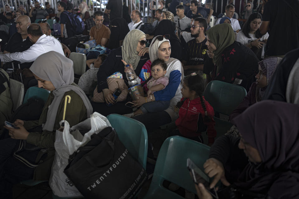 Palestinians wait to cross into Egypt at Rafah, Gaza Strip, on Wednesday, Nov. 1, 2023. (AP Photo/Fatima Shbair)