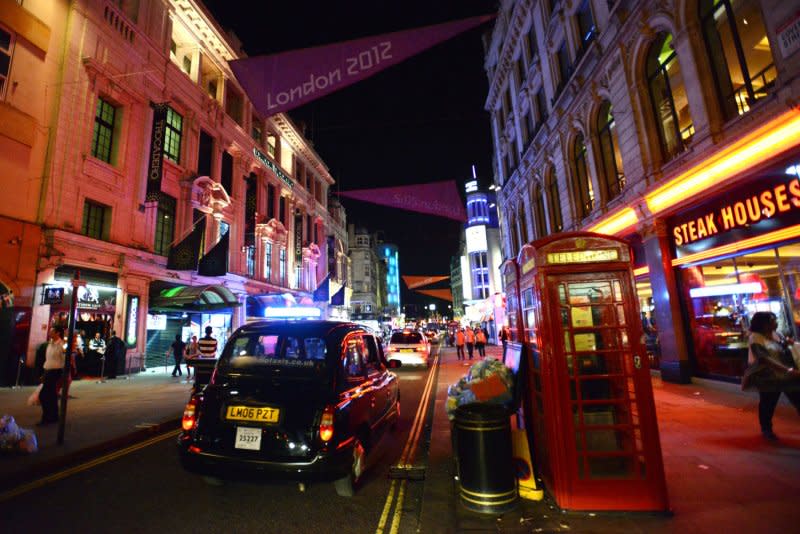 A classic British telephone booth adorns a street near Leicester Square in London on July 24, 2012. On January 6, 1927, commercial trans-Atlantic telephone service between New York and London was inaugurated. File Photo by Pat Benic/UPI