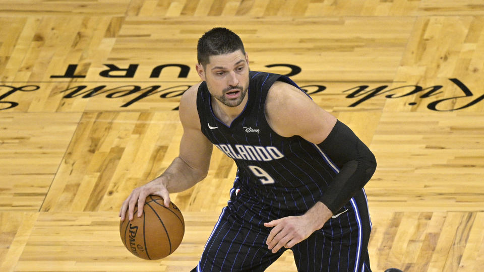 Orlando Magic center Nikola Vucevic (9) sets up a play during the second half of an NBA basketball game against the Miami Heat on Sunday, March 14, 2021, in Orlando, Fla. (AP Photo/Phelan M. Ebenhack)