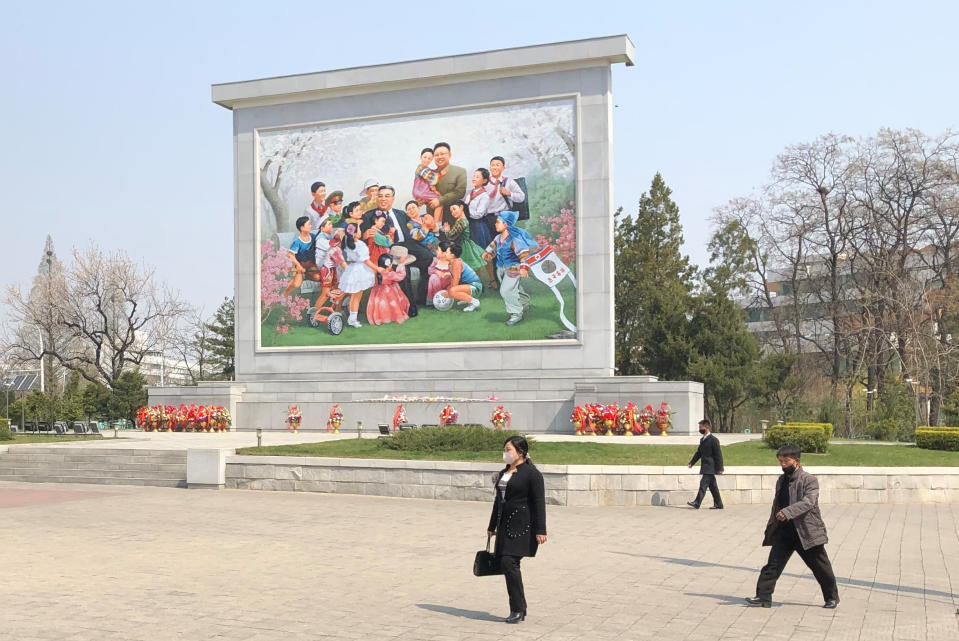 People walk past a mosaic depicting supreme North Korean leaders Kim Il-sung and Kim Jong-il in eastern Pyongyang. Source: AAP