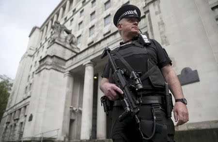 An armed police officer patrols near the Ministry of Defence in London, Britain May 11, 2016. REUTERS/Neil Hall