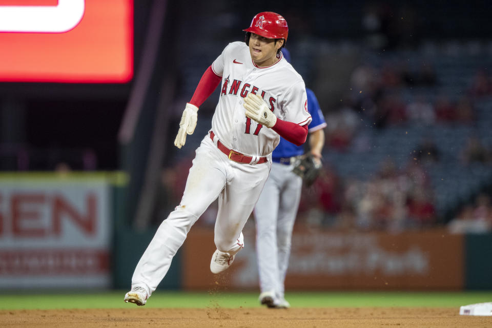 Los Angeles Angels' Shohei Ohtani runs past second heading for third on a Taylor Ward double during the first inning of the team's baseball game against the Texas Rangers in Anaheim, Calif., Friday, Sept. 30, 2022. (AP Photo/Alex Gallardo)