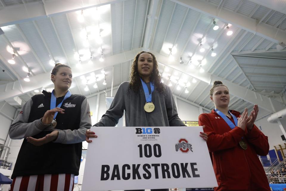 Ohio State sophomore Nyah Funderburke, center, won the Big Ten championship in the 100-yard backstroke. The 2021 Columbus School for Girls graduate also swam on three winning relays.