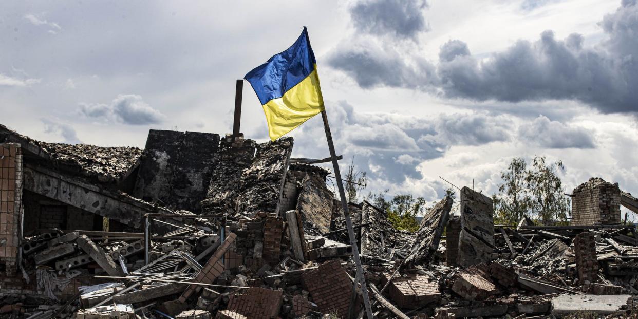 A Ukrainian flag waves in the village of Dolyna in Donetsk Oblast, Ukraine after the withdrawal of Russian troops on September 24, 2022.