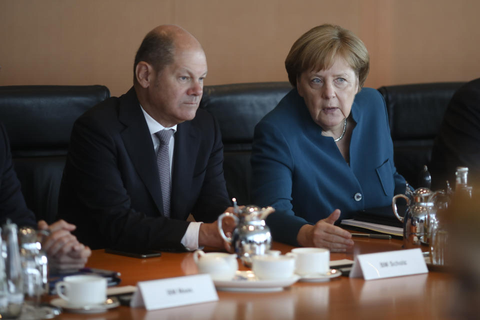 German Chancellor Angela Merkel, right, talks to Vice Chancellor and Finance Minister Olaf Scholz, left, during the weekly cabinet meeting of the German government at the chancellery in Berlin, Wednesday, May 29, 2019. (AP Photo/Markus Schreiber)