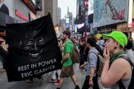 Protesters march through Times Square taking part in a march for Eric Garner who was killed one year ago by police in New York July 17, 2015.  REUTERS/Eduardo Munoz