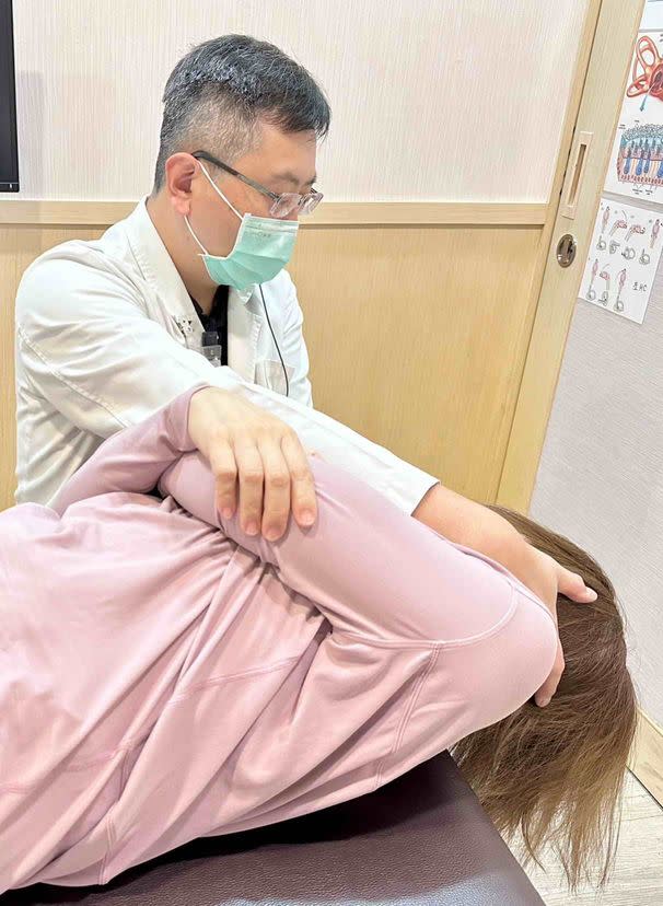 陳建志醫師正以耳石復位術治療旅遊暈眩症患者。（記者黃福鎮翻攝）