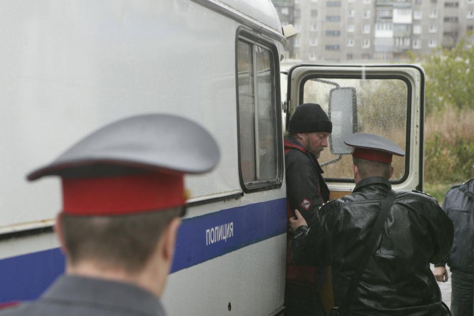 Handout shows a Greenpeace International activist from Canada, arrested for staging a protest at Russia's first Arctic offshore oil platform, arriving at the Leninsky District Court in Murmansk