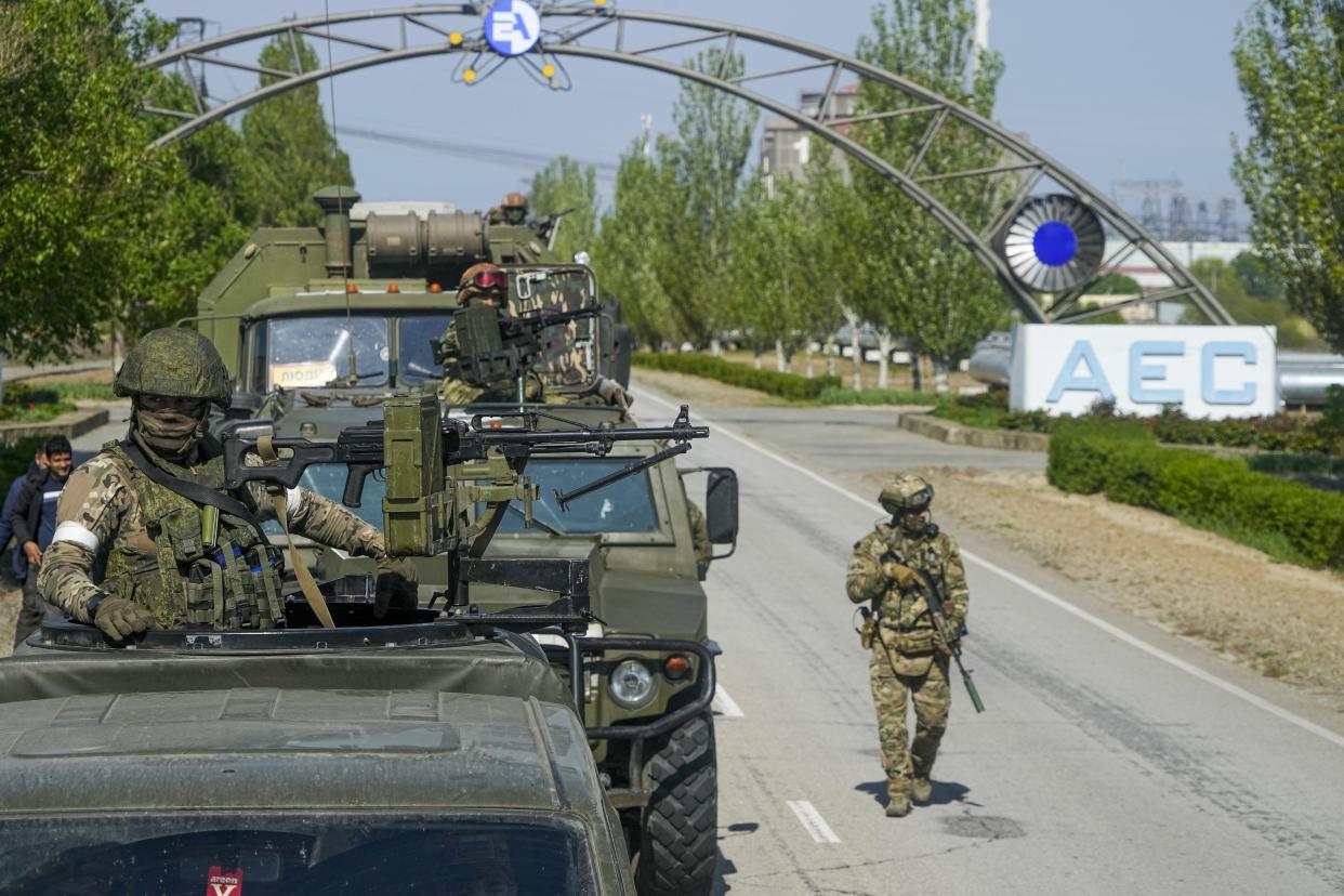 FILE - A Russian military convoy is seen on the road toward the Zaporizhzhia Nuclear Power Station, in Enerhodar, Zaporizhzhia region, in territory under Russian military control, southeastern Ukraine, on May 1, 2022. The Zaporizhzhia plant is in southern Ukraine, near the town of Enerhodar on the banks of the Dnieper River. It is one of the 10 biggest nuclear plants in the world. Russia and Ukraine have accused each other of shelling Europe's largest nuclear power plant, stoking international fears of a catastrophe on the continent. This photo was taken during a trip organized by the Russian Ministry of Defense. (AP Photo, File)