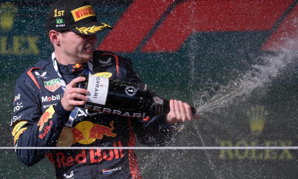 Max Verstappen celebrates by spraying champagne after winning the Brazilian grand prix.