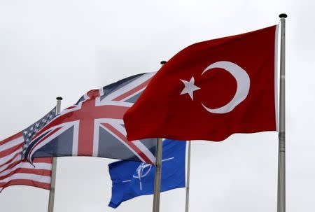 A Turkish flag (R) flies among others flags of NATO members during the North Atlantic Council (NAC) following Turkey's request for Article 4 consultations, at the Alliance headquarters in Brussels, Belgium, July 28, 2015. REUTERS/Francois Lenoir