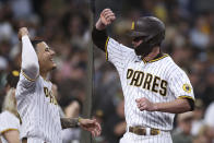 San Diego Padres' Wil Myers, right, is congratulated by Manny Machado after hitting a home run during the second inning of the team's baseball game against the Cincinnati Reds on Friday, June 18, 2021, in San Diego. (AP Photo/Derrick Tuskan)