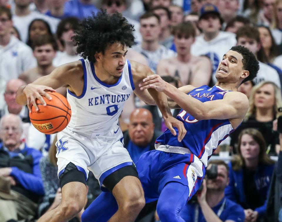 Kansas guard Kecin McCullar, Jr.draws the charge against Kentucky forward Jacob Toppin in the second half at Rupp Arena. Jan. 28, 2023