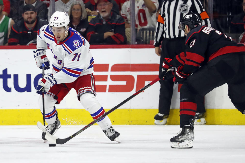 Carolina Hurricanes' Nino Niederreiter (21) tips the puck away from New York Rangers' Keith Kinkaid (71) during the second period of Game 1 of an NHL hockey Stanley Cup second-round playoff series in Raleigh, N.C., Wednesday, May 18, 2022. (AP Photo/Karl B DeBlaker)