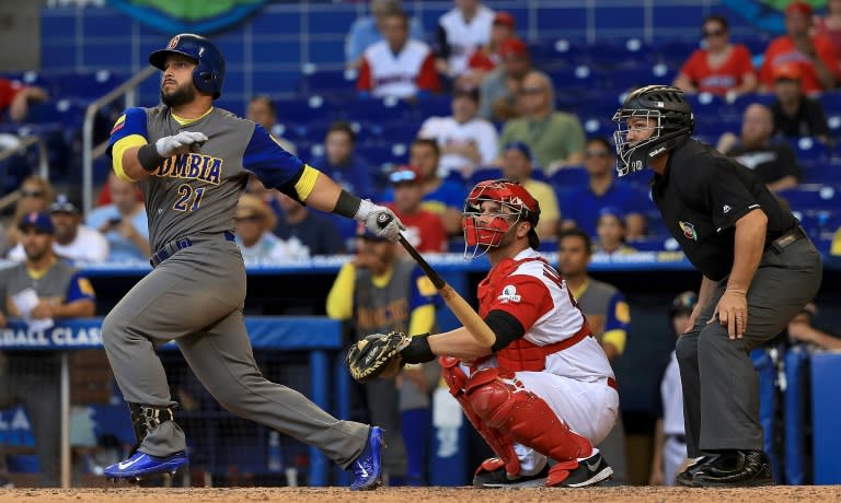 Jhonatan Solano of Colombia hits a double during the ninth inning against Canada on the way to a 4-1 win in the World Baseball Classic